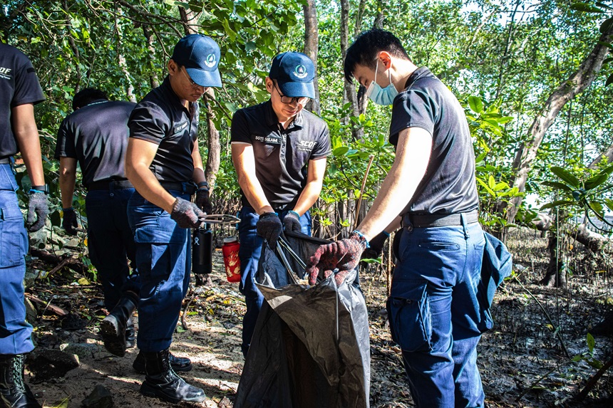 CDA officers including NSFs doing a coastal clean-up of the mangrove swamp