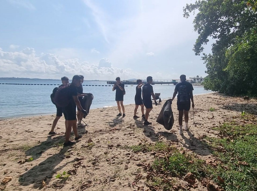 Personnel from SCDF 2nd Division cleaning up the beach at Changi Beach