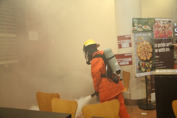 <p>Jurong Point's in-house Company Emergency Response Team (CERT) fighting the fire before SCDF's arrival</p>