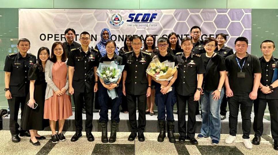 Ms Khoo (front row, fifth from the left) and LTA Chong Wee (front row, fifth from the right) with Commissioner Eric Yap (centre) at the Welcome Reception after returning to Singapore from the OLH deployment
