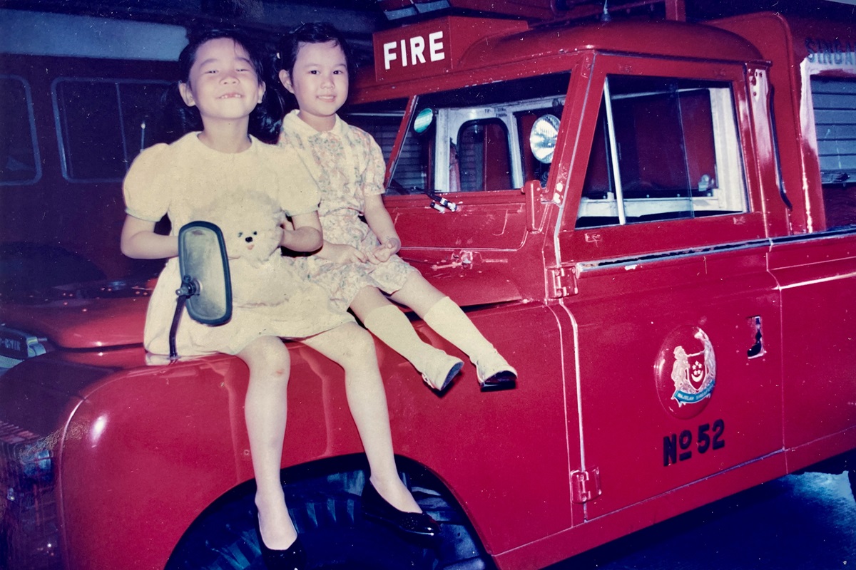 Bernice Huang (left) and Beverlyn Huang (right) on a Light Water Tender landrover at Alexandra Fire Station