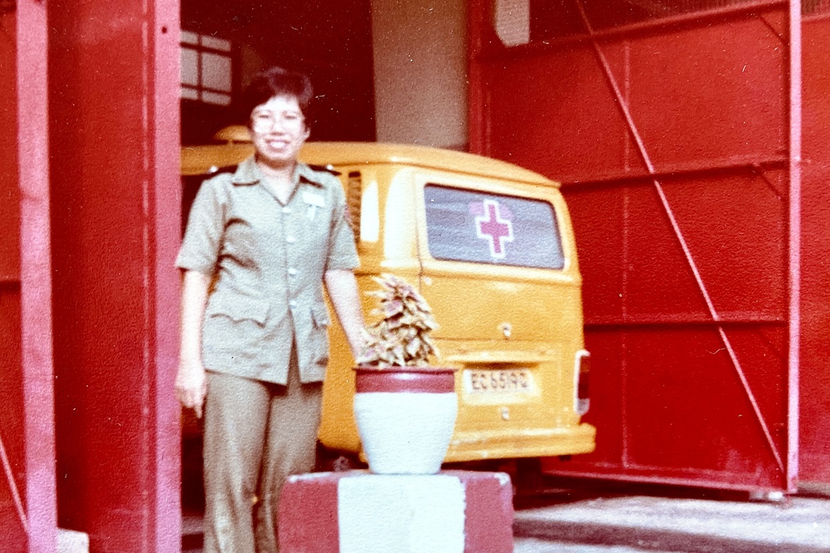 Mdm Beatrice Ho in front of the Volkswagen Transporter ambulance at Alexandra Fire Station