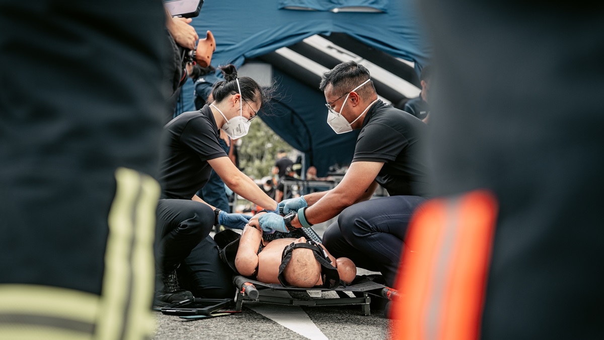 SCDF EMS officers assessing casualties prior to conveyance