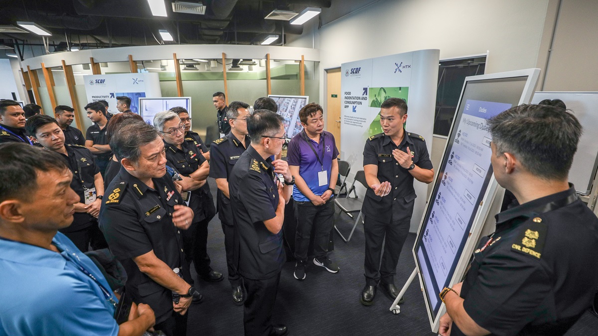 Mr Ling Kok Yong, COMR Eric Yap and SCDF SM given a brief walkthrough on the functions of the RDR app