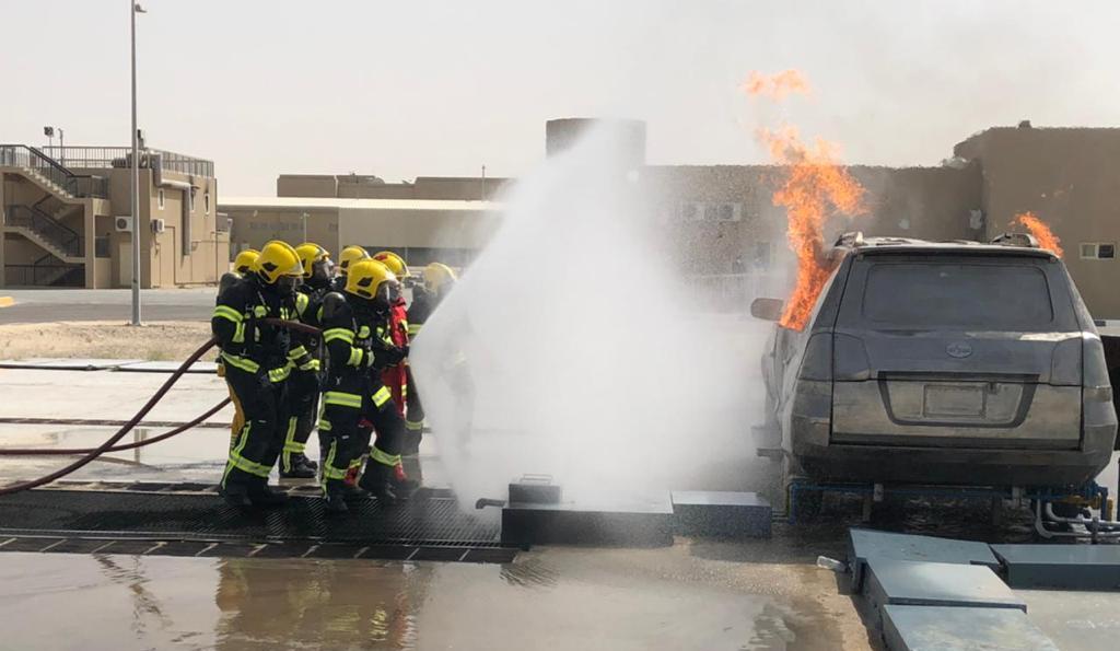 SWO (RET) Selamat (man in red) leading his trainees through a vehicle fire training