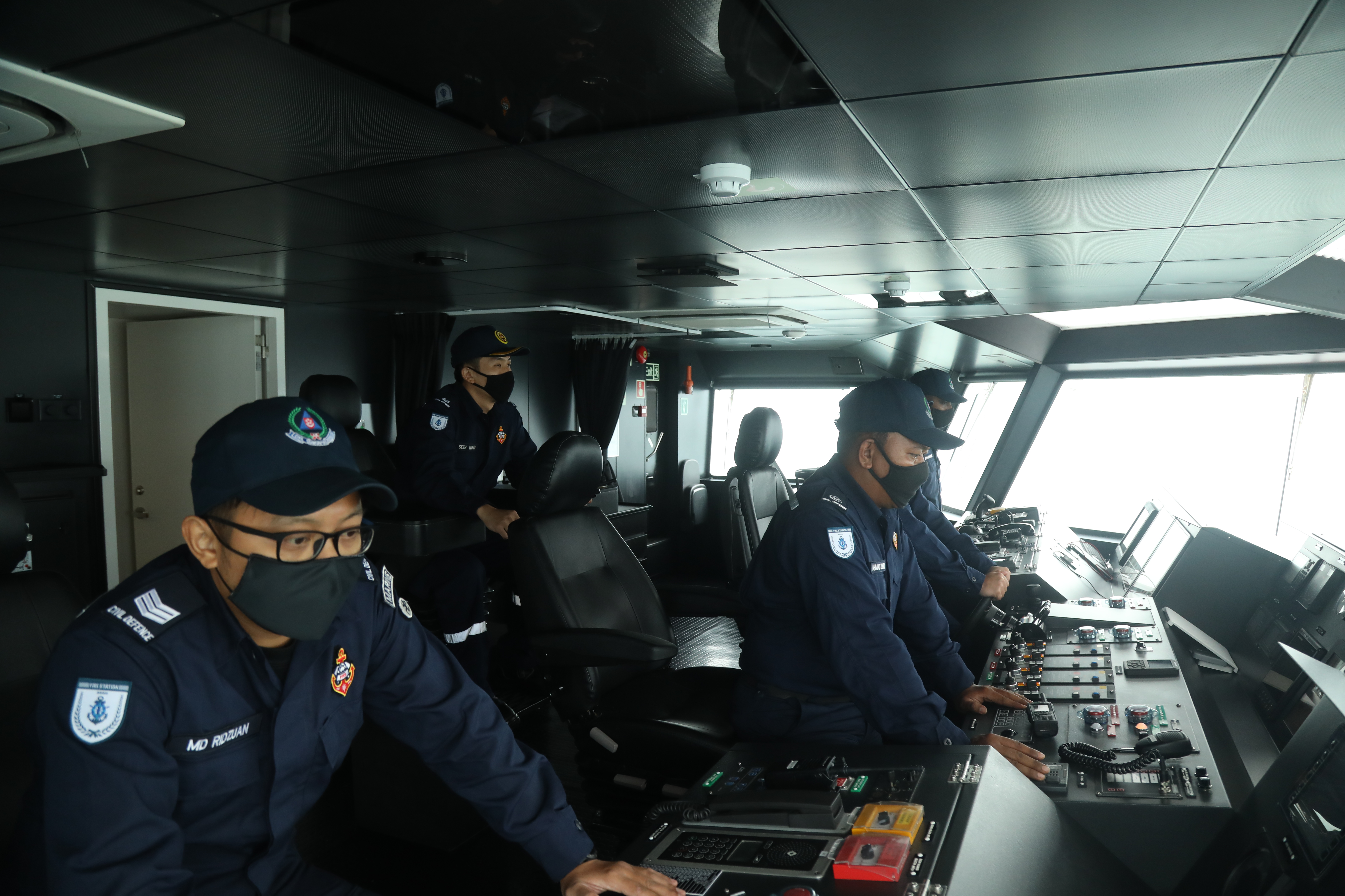 SCDF Marine officers controlling the vessel from the command room.