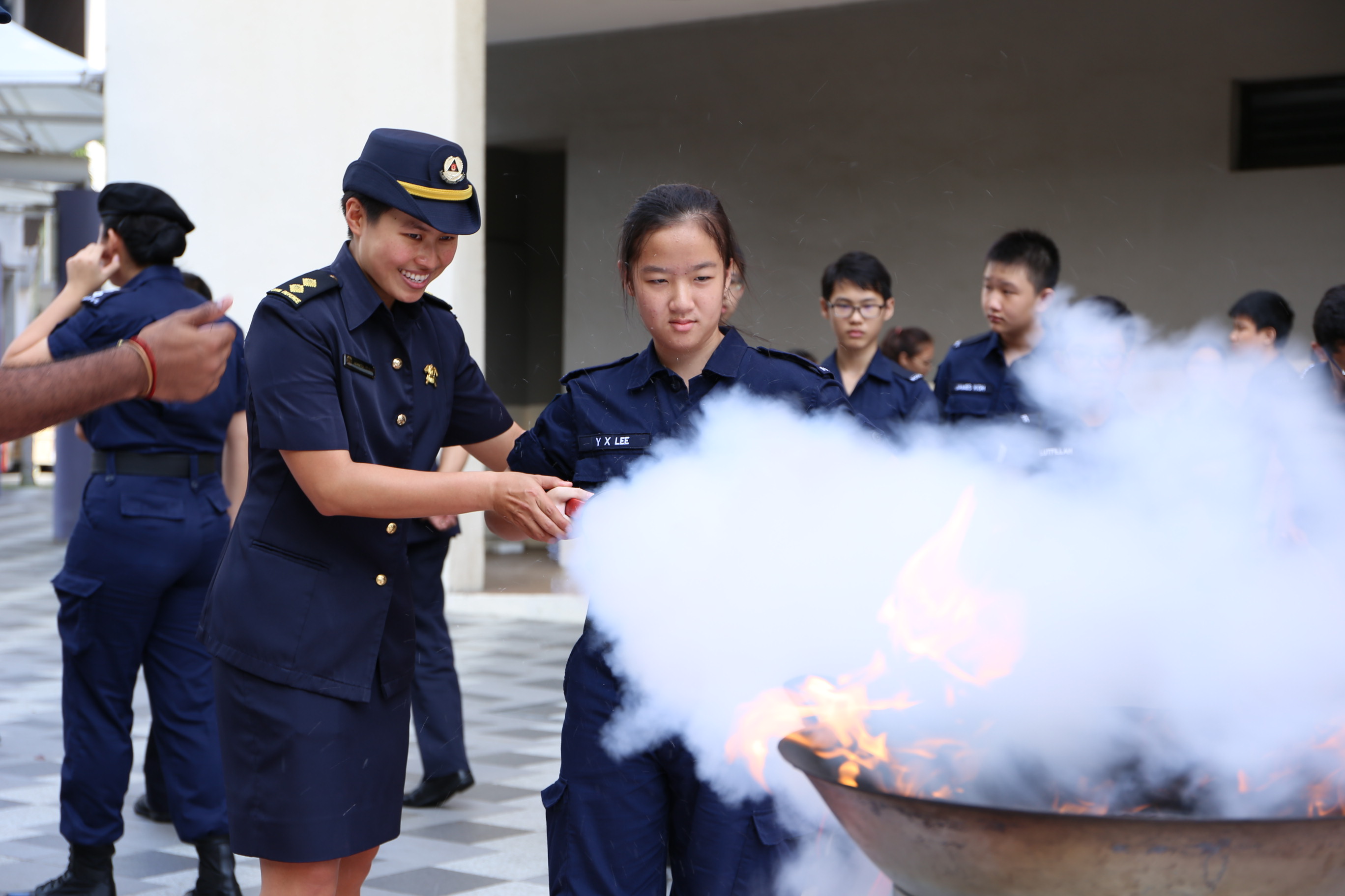 Jadyn teaching cadets how to use a fire extinguisher