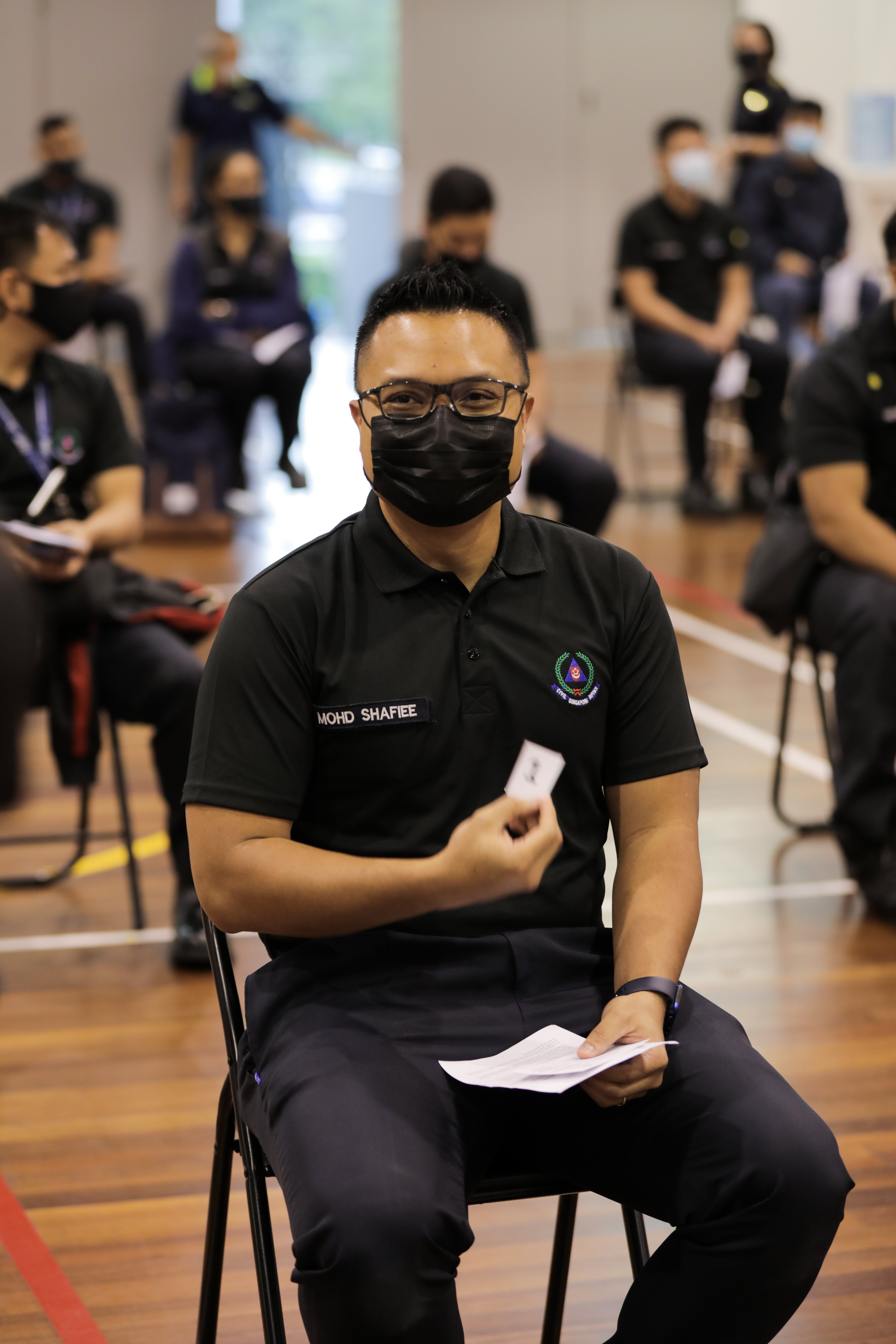 WO1 Mohamed Shafiee bin Jamin waiting in line with other SCDF officers for his turn to receive the vaccination.