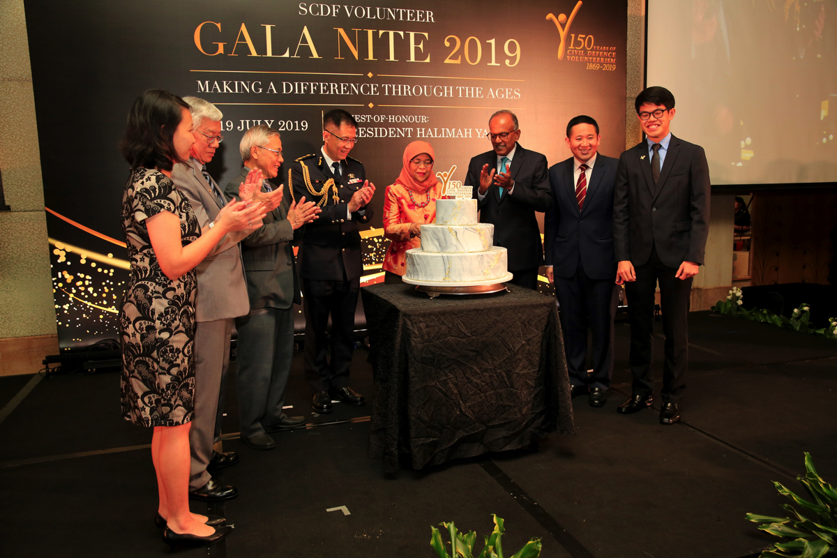 Cake-cutting by Mdm President to commemorate 150 Years of CD Volunteerism
