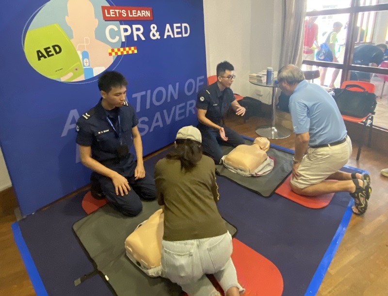 Community Engagement Specialists imparting CPR-AED skills to the residents. PHOTO - SCDF : Thomas Lim