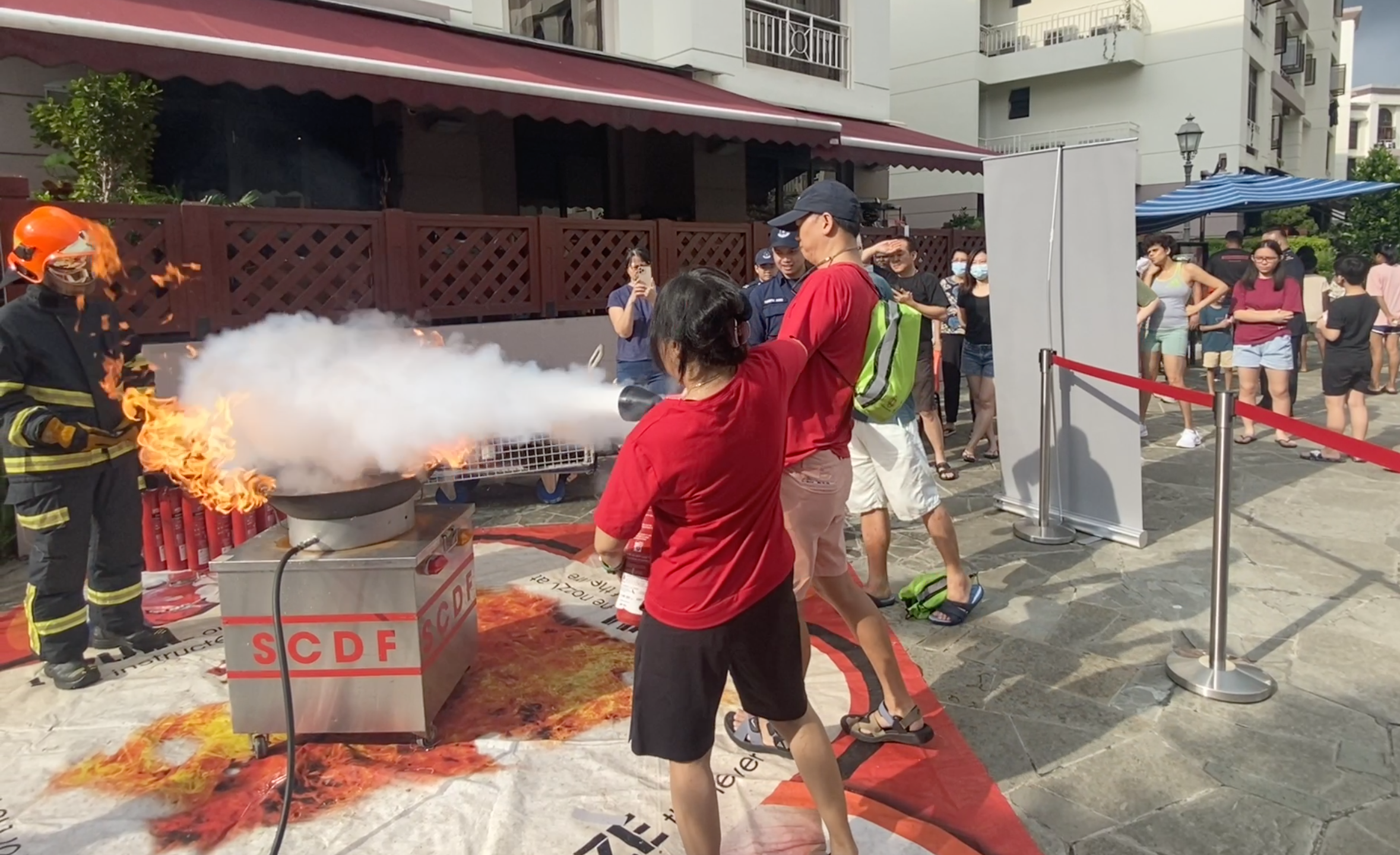 Residents having hands-on training with fire extinguishers. PHOTO - SCDF : Thomas Lim